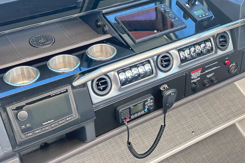 Slide: The Image of 2023 Formula 380 Super Sport Crossover OB dashboard with controls and cup holders. - 18