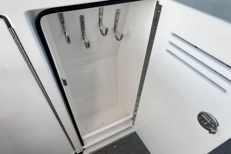Slide: The Image of 2023 Formula 380 Super Sport Crossover OB storage compartment with hooks and latch. - 25