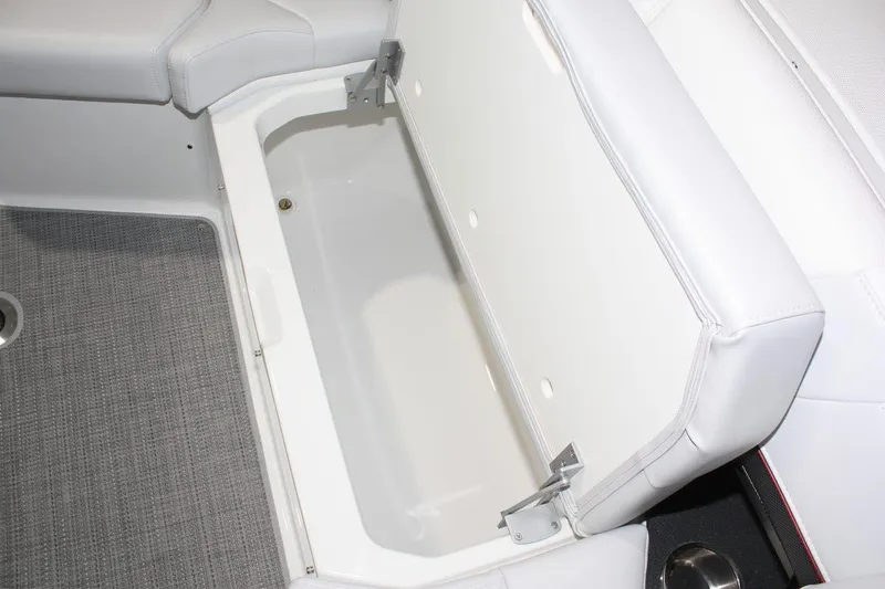 Slide: The Image of 2023 Formula 380 Super Sport Crossover OB boat storage compartment with open white cushioned lid. - 37