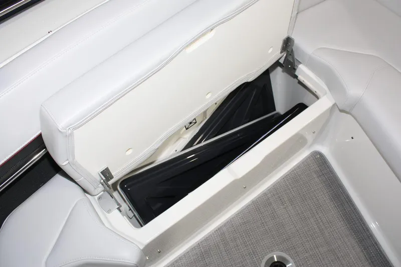 Slide: The Image of 2023 Formula 380 Super Sport Crossover OB boat storage compartment with open seat and visible interior. - 38