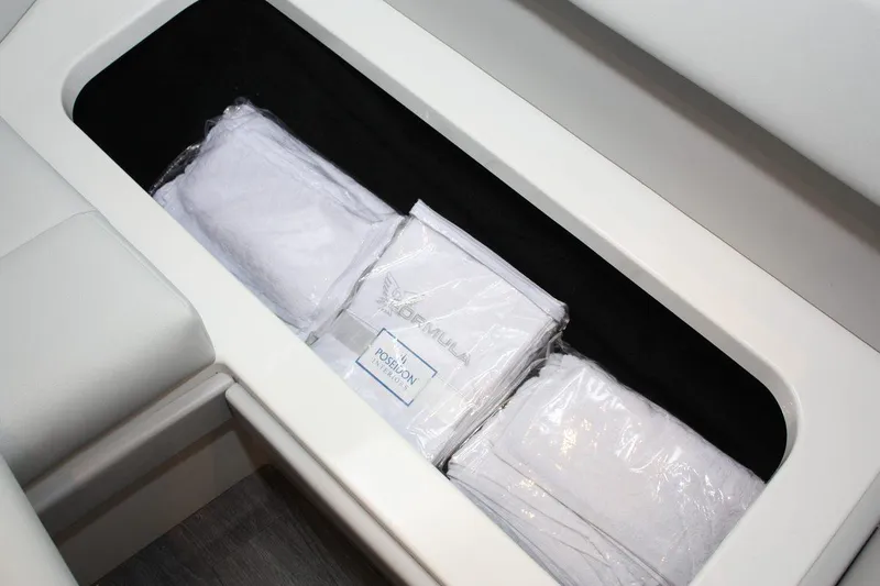 Slide: The Image of Storage compartment with packaged linens in a 2023 Formula 380 Super Sport Crossover OB. - 47