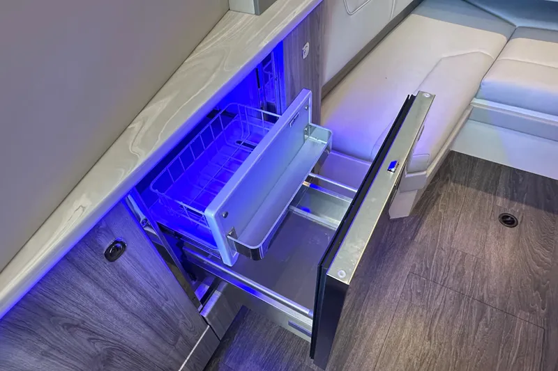 Slide: The Image of 2023 Formula 380 Super Sport Crossover OB interior with open drawer and blue lighting. - 56
