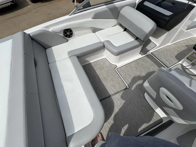 Slide: The Image of 2019 Regal 1900 ES boat interior with gray and white seating and flooring. - 12
