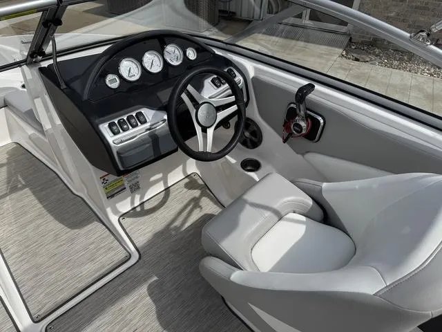 Slide: The Image of 2019 Regal 1900 ES boat interior with steering wheel and dashboard controls. - 13