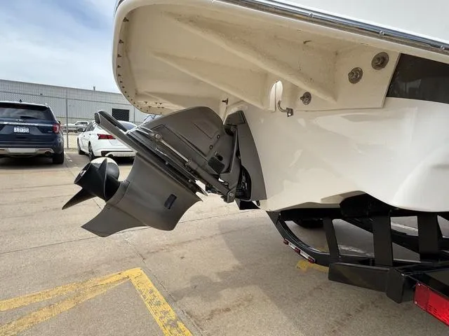 Slide: The Image of 2019 Regal 1900 ES boat with outboard motor, parked on a trailer. - 4