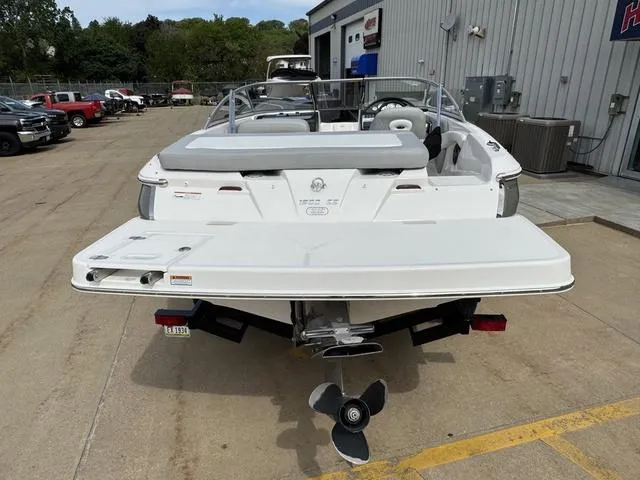 Slide: The Image of 2019 Regal 1900 ES boat, rear view, parked outdoors near a building. - 5
