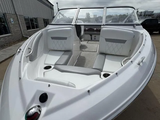 Slide: The Image of 2019 Regal 1900 ES boat with white interior and seating, docked outdoors. - 6