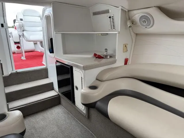 Slide: The Image of Interior of a 2000 Baja 36 Outlaw boat with seating and kitchenette. - 15