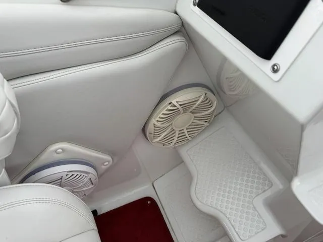 Slide: The Image of Interior of a 2000 Baja 36 Outlaw boat with white seating and built-in speakers. - 17