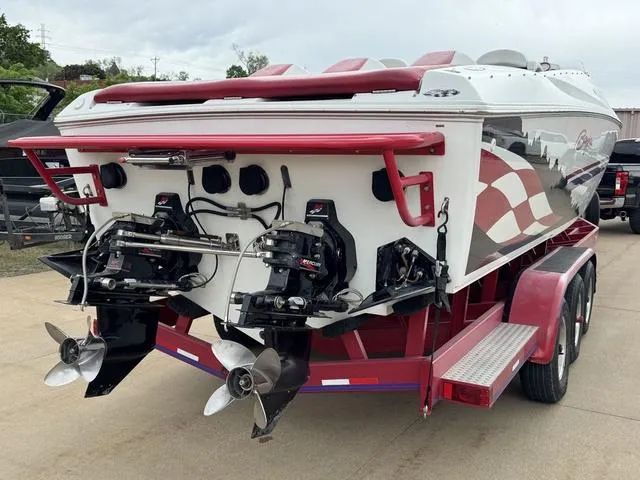 Slide: The Image of 2000 Baja 36 Outlaw speedboat on trailer, dual propellers, red and white design. - 4