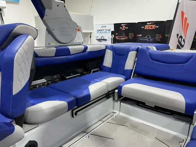 Slide: The Image of 2021 Malibu M220 boat interior with blue and white seating, showcasing modern design and comfort. - 13