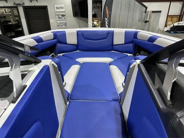 Slide: The Image of Interior view of 2021 Malibu M220 boat with blue and white seating. - 14