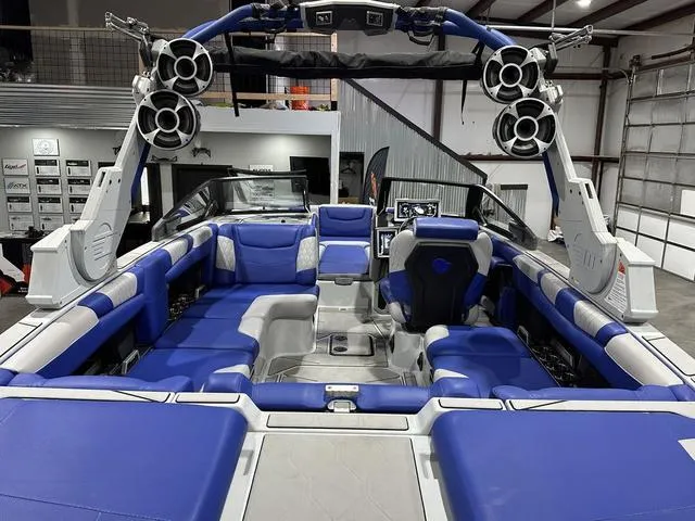 Slide: The Image of 2021 Malibu M220 boat interior with blue seating and advanced audio system. - 7