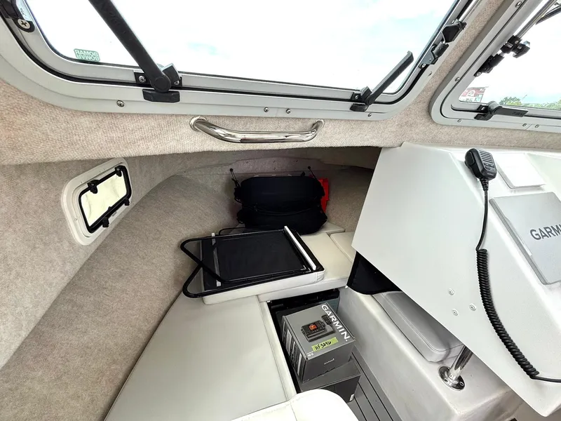 Slide: The Image of 2022 Parker 2320 Sport Cabin interior with Garmin equipment and seating area. - 13