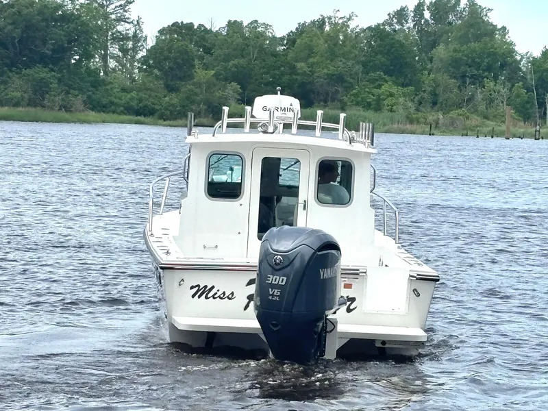 Slide: The Image of 2022 Parker 2320 Sport Cabin boat with Yamaha 300 engine on a lake. - 6