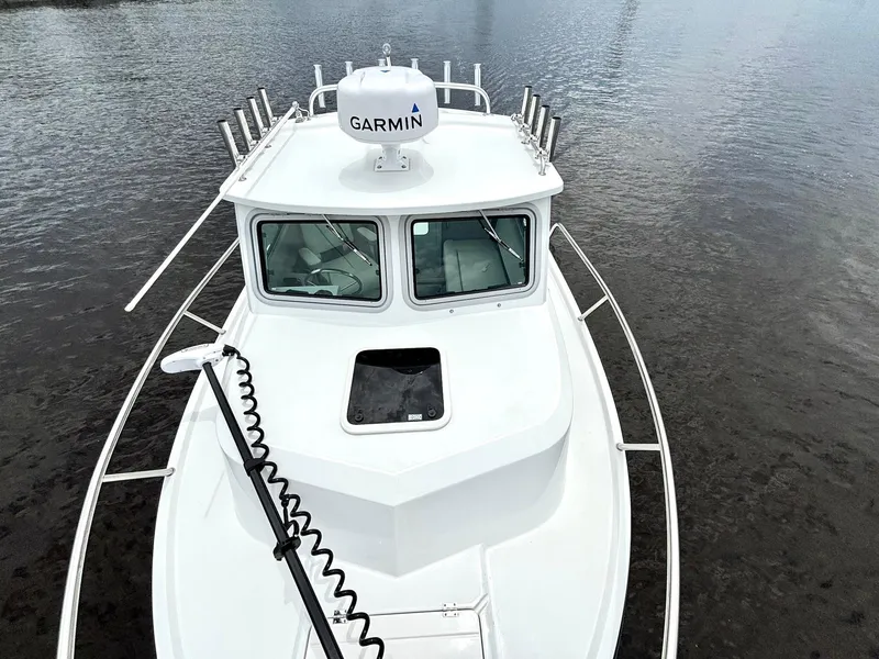 Slide: The Image of 2022 Parker 2320 Sport Cabin boat with Garmin radar on calm water. - 9