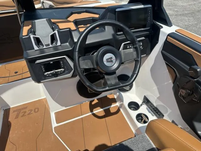 Slide: The Image of 2025 Axis Wake Research T Series T220 boat interior with steering wheel and dashboard. - 11