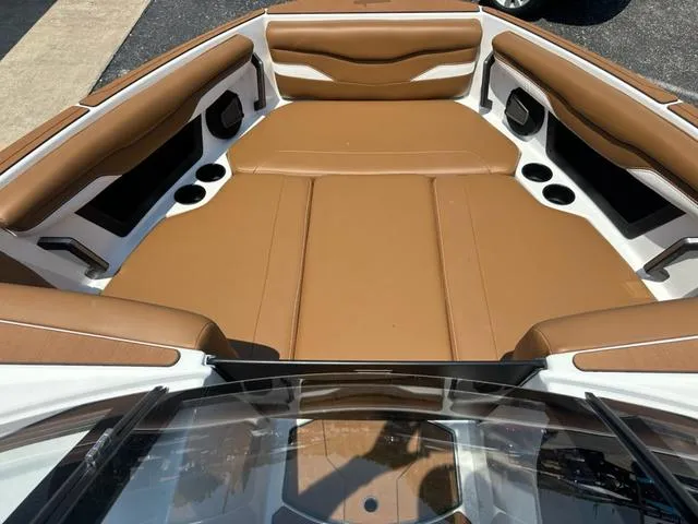 Slide: The Image of 2025 Axis Wake Research T Series T220 boat interior with brown seating and cup holders. - 12