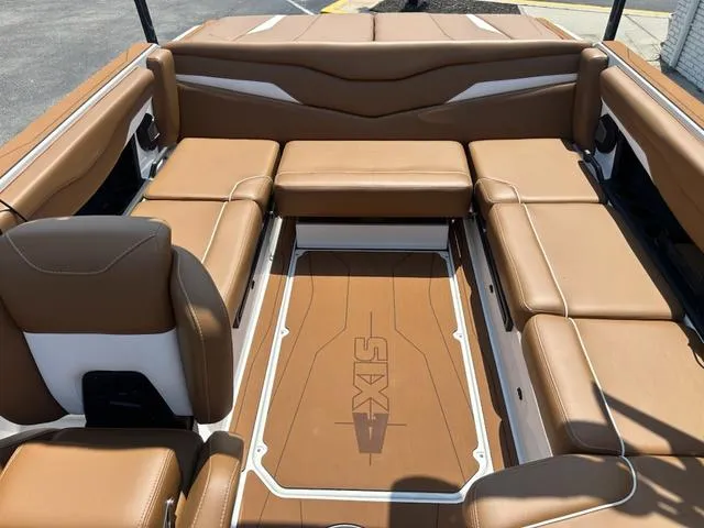Slide: The Image of 2025 Axis Wake Research T Series T220 boat interior with tan seating and logo flooring. - 13