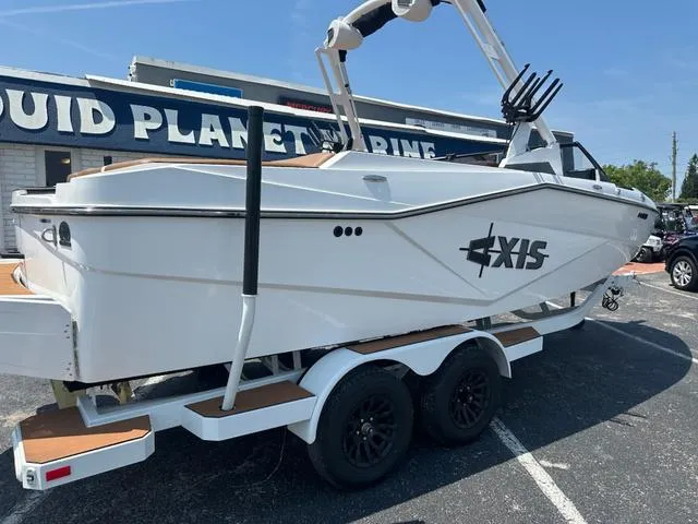 Slide: The Image of 2025 Axis Wake Research T Series T220 boat on trailer at dealership. - 4