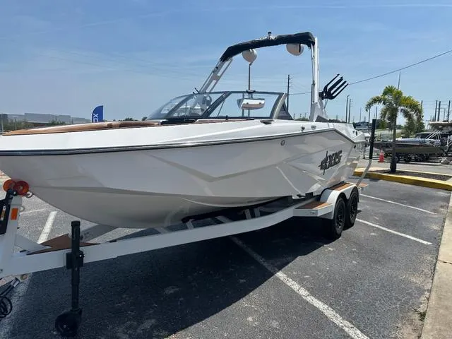 Slide: The Image of 2025 Axis Wake Research T Series T220 boat on trailer in parking lot. - 6