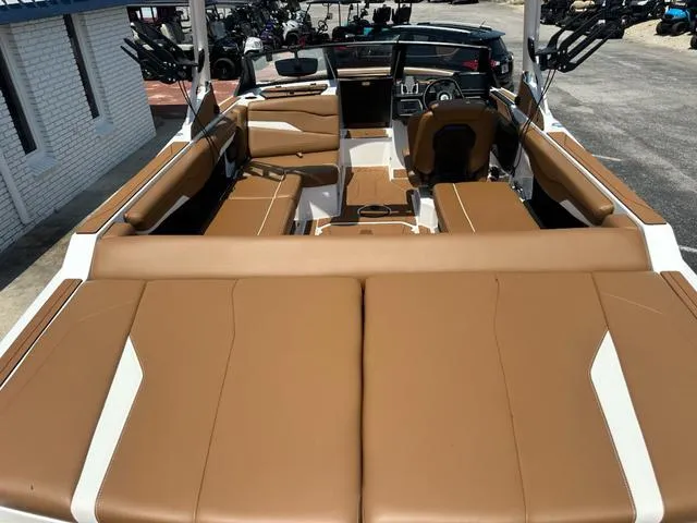 Slide: The Image of 2025 Axis Wake Research T Series T220 boat interior with tan and white seating. - 7