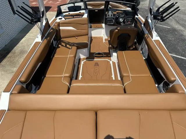 Slide: The Image of 2025 Axis Wake Research T Series T220 boat interior with tan seating and modern dashboard. - 8