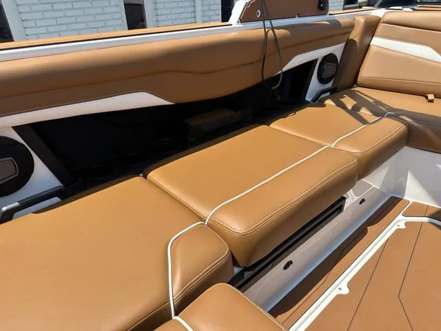 Slide: The Image of 2025 Axis Wake Research T Series T220 boat interior with tan leather seating. - 9