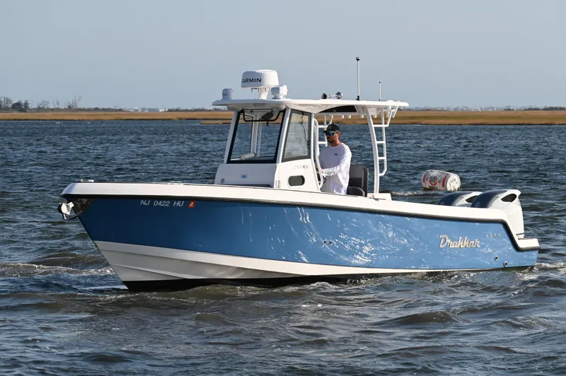 Slide: The Image of 2022 Drakkar 280 CC boat cruising on open water. - 10