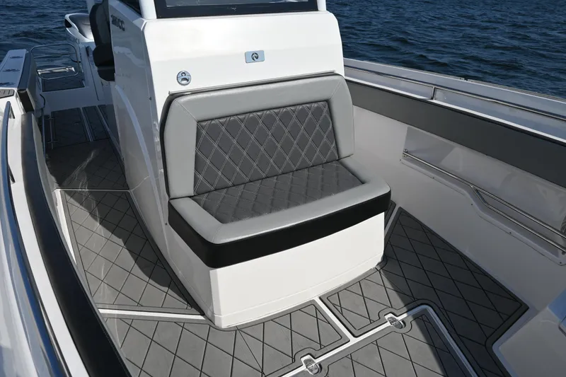 Slide: The Image of 2022 Drakkar 280 CC boat interior with gray cushioned seating and diamond-patterned flooring. - 13