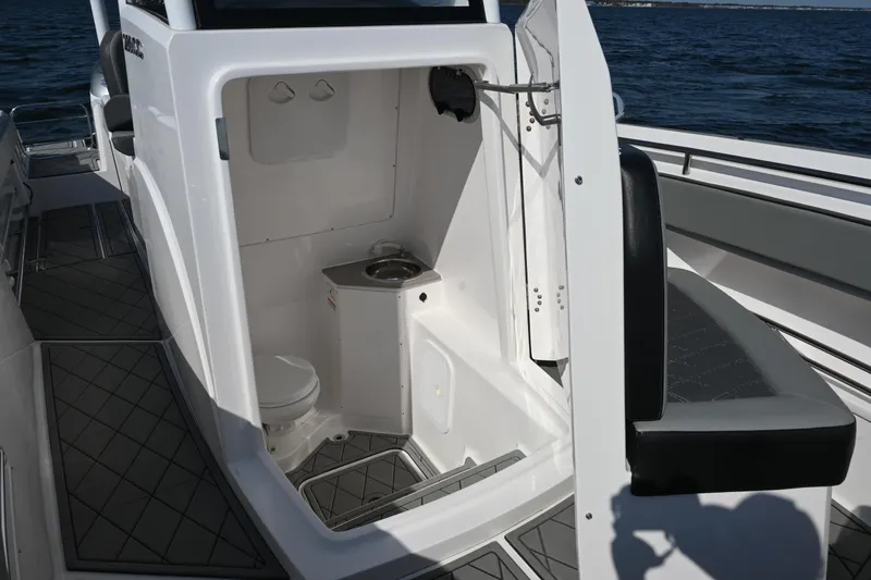 Slide: The Image of 2022 Drakkar 280 CC boat interior with compact bathroom and sink. - 14