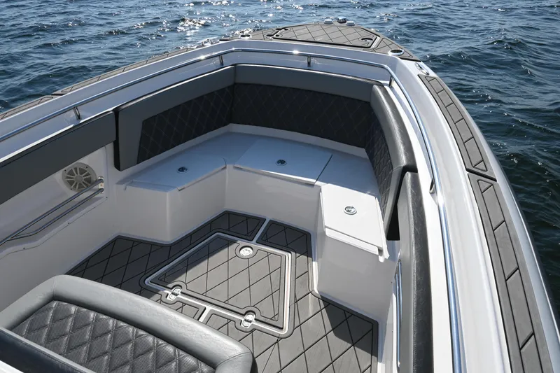 Slide: The Image of 2022 Drakkar 280 CC boat interior with cushioned seating and ocean view. - 15