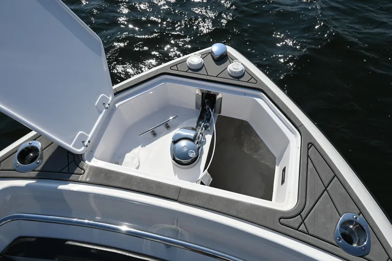 Slide: The Image of Open anchor compartment on 2022 Drakkar 280 CC boat, showing anchor and storage space. - 19