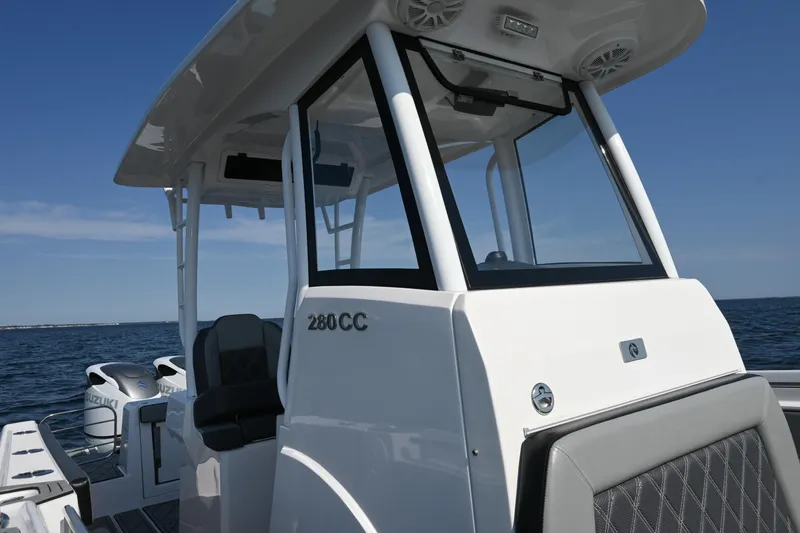 Slide: The Image of 2022 Drakkar 280 CC boat on open water, featuring sleek design and modern cockpit. - 22