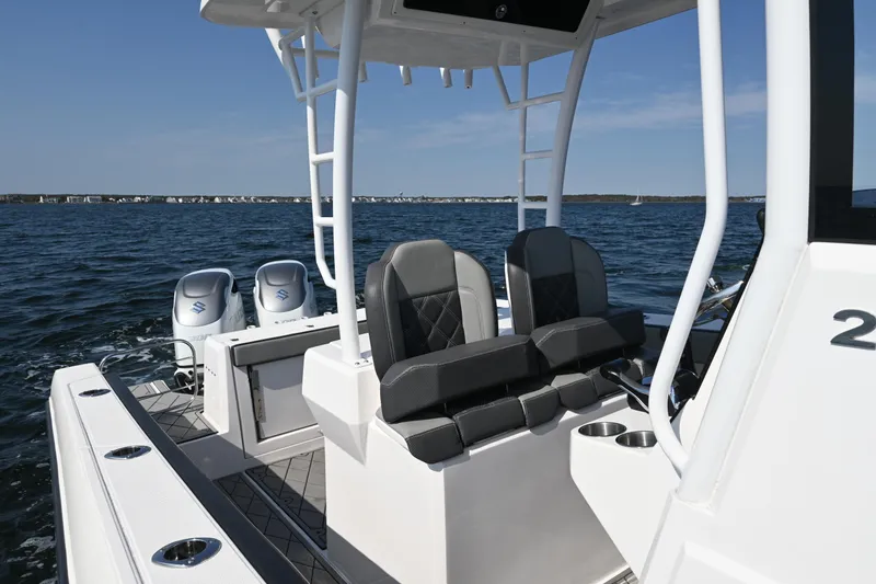Slide: The Image of 2022 Drakkar 280 CC boat interior with dual seats and twin engines on open water. - 23