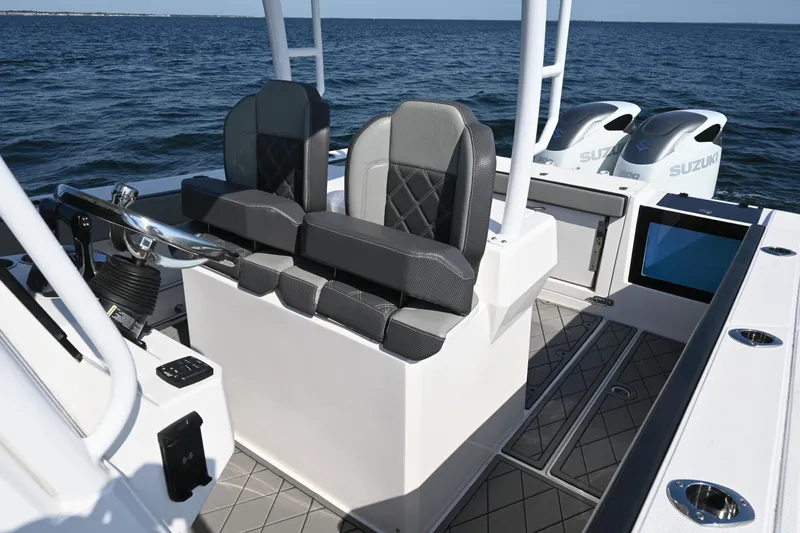 Slide: The Image of 2022 Drakkar 280 CC boat interior with dual seats and Suzuki engines on open water. - 25