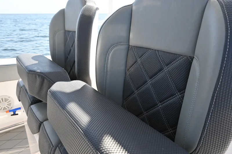 Slide: The Image of Luxurious seating on 2022 Drakkar 280 CC boat with ocean backdrop. - 26