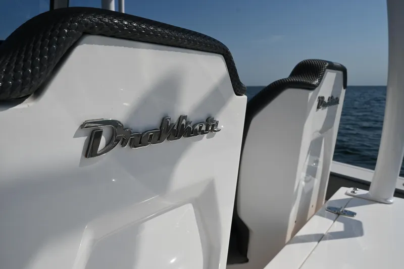 Slide: The Image of 2022 Drakkar 280 CC boat seats with logo, ocean background. - 27