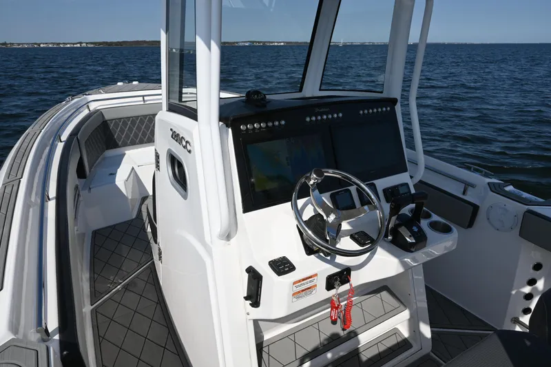 Slide: The Image of 2022 Drakkar 280 CC boat cockpit with modern steering and navigation system on open water. - 28