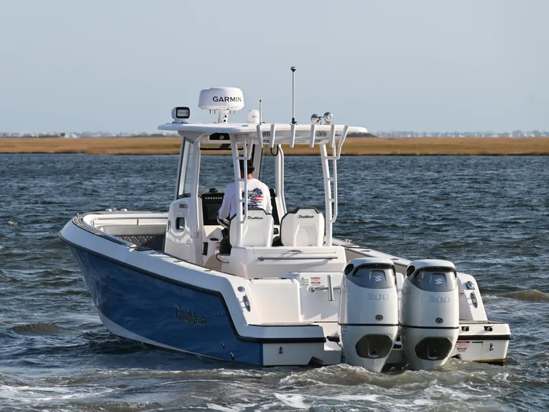 Slide: The Image of 2022 Drakkar 280 CC boat with dual engines navigating coastal waters. - 3