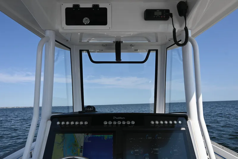 Slide: The Image of Interior view of 2022 Drakkar 280 CC boat cockpit with ocean horizon. - 34