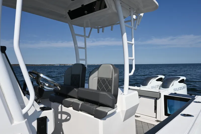 Slide: The Image of 2022 Drakkar 280 CC boat interior with dual Suzuki engines on open water. - 35