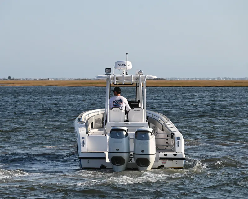 Slide: The Image of 2022 Drakkar 280 CC boat cruising on open water with dual engines. - 4