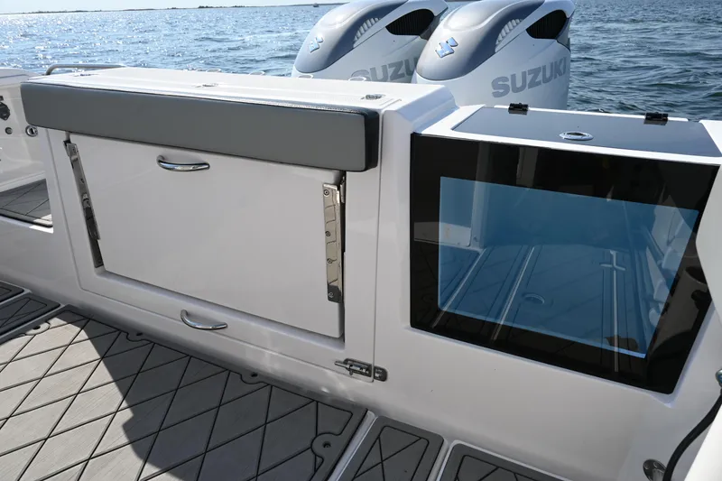 Slide: The Image of 2022 Drakkar 280 CC boat with Suzuki engines, featuring storage and seating area. - 41