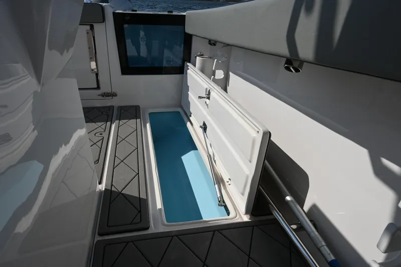 Slide: The Image of 2022 Drakkar 280 CC boat interior with open storage compartment. - 46
