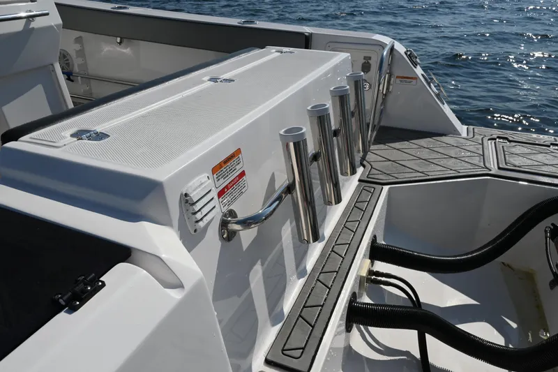 Slide: The Image of 2022 Drakkar 280 CC boat deck with rod holders and storage. - 47