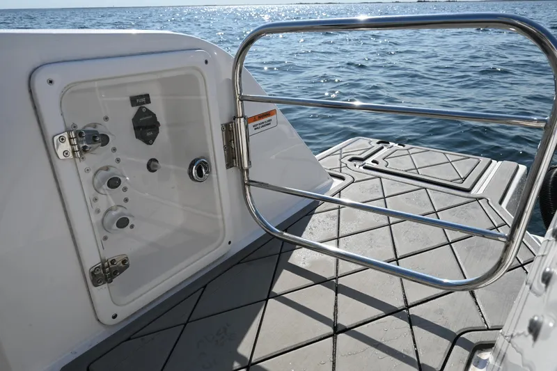 Slide: The Image of 2022 Drakkar 280 CC boat deck with open gate, overlooking the ocean. - 48