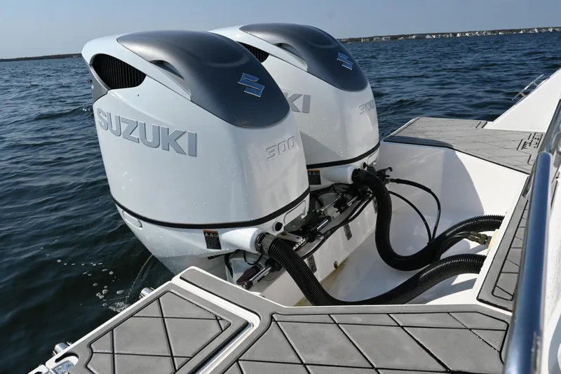Slide: The Image of Twin Suzuki outboard engines on a 2022 Drakkar 280 CC boat in open water. - 49