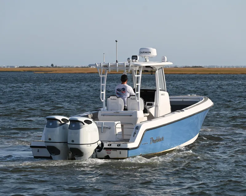 Slide: The Image of 2022 Drakkar 280 CC boat cruising on open water with dual engines. - 5