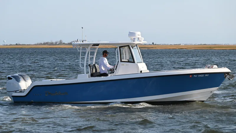 Slide: The Image of 2022 Drakkar 280 CC boat cruising on open water. - 7